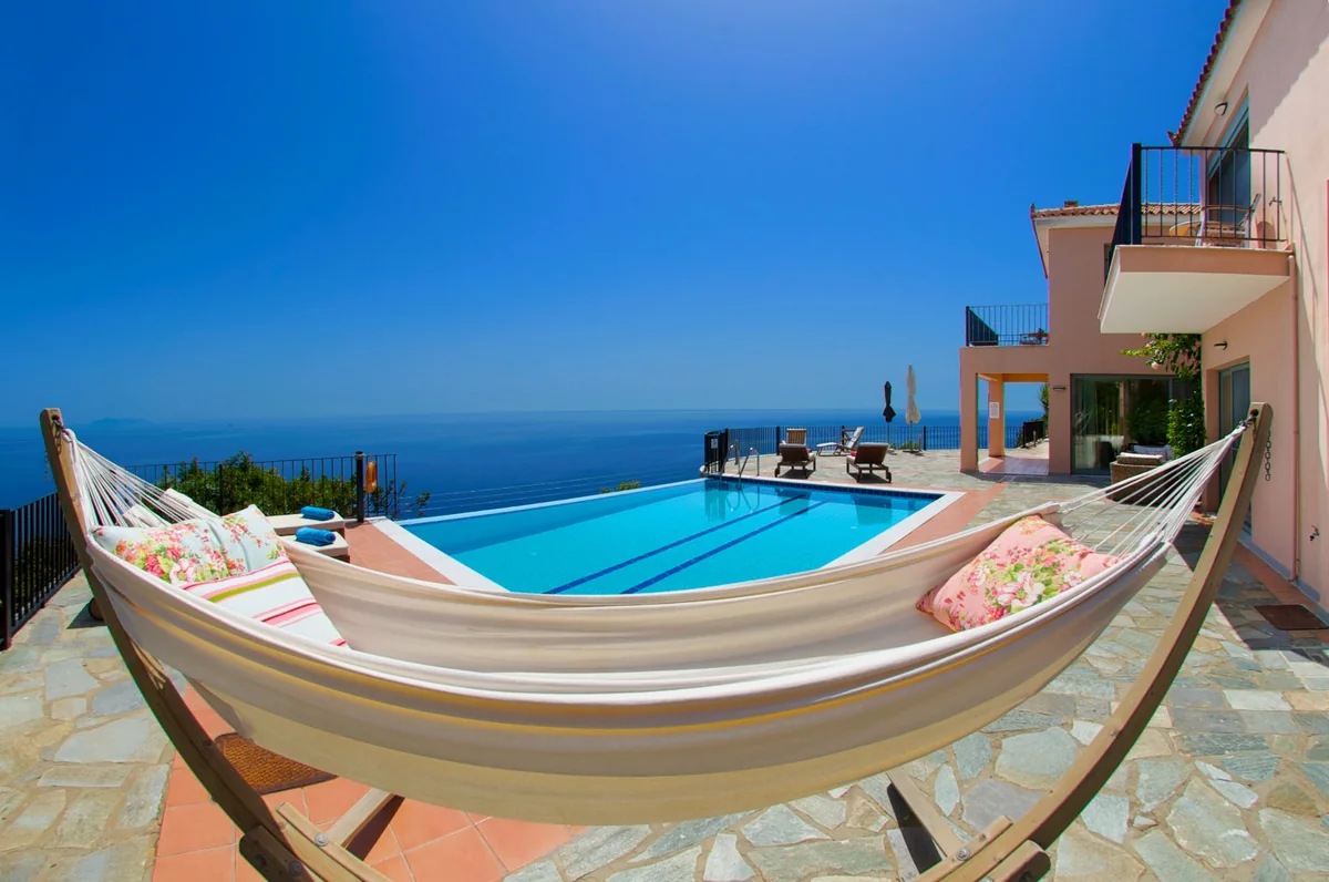 Hammock beside Villa Alkionis infinity pool overlooking the sea
